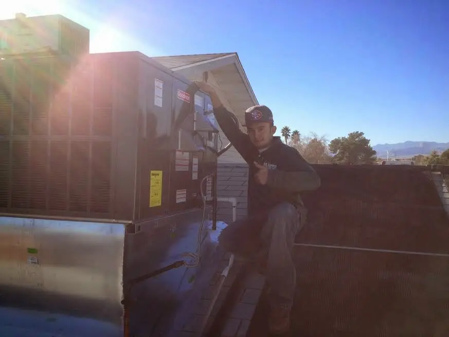 HVAC technician performing Heat Pump Repair on a rooftop unit in Hardeeville