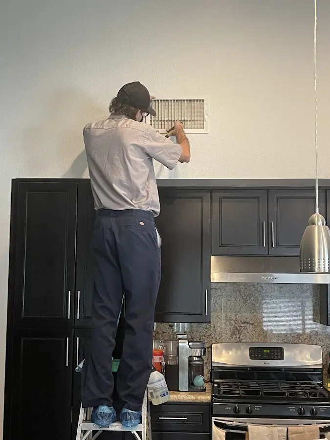 Technician inspecting an air vent during HVAC service in Hardeeville